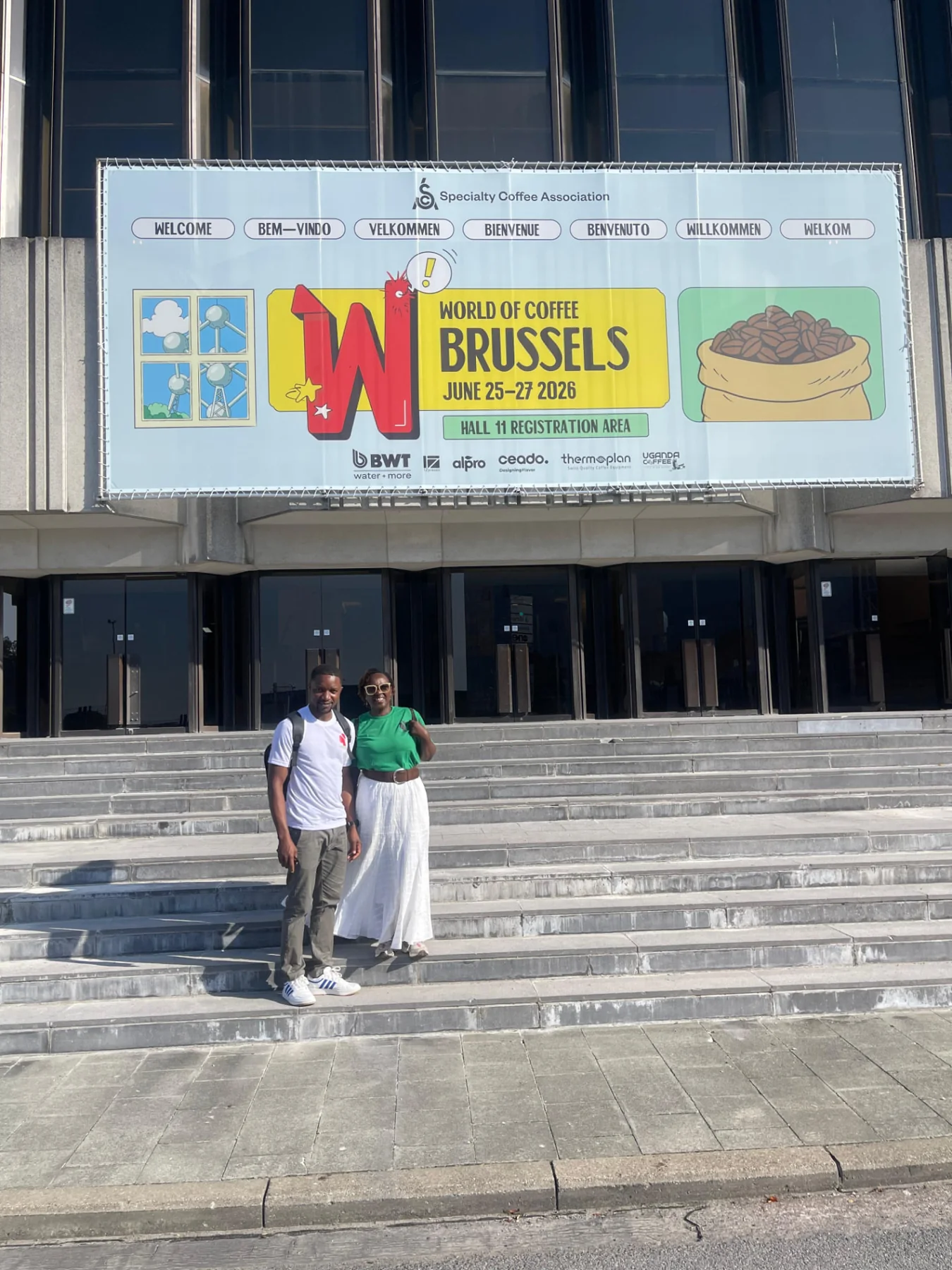 Diane Nsengiyumva and a companion on the Brussels Expo steps during World of Coffee 2026