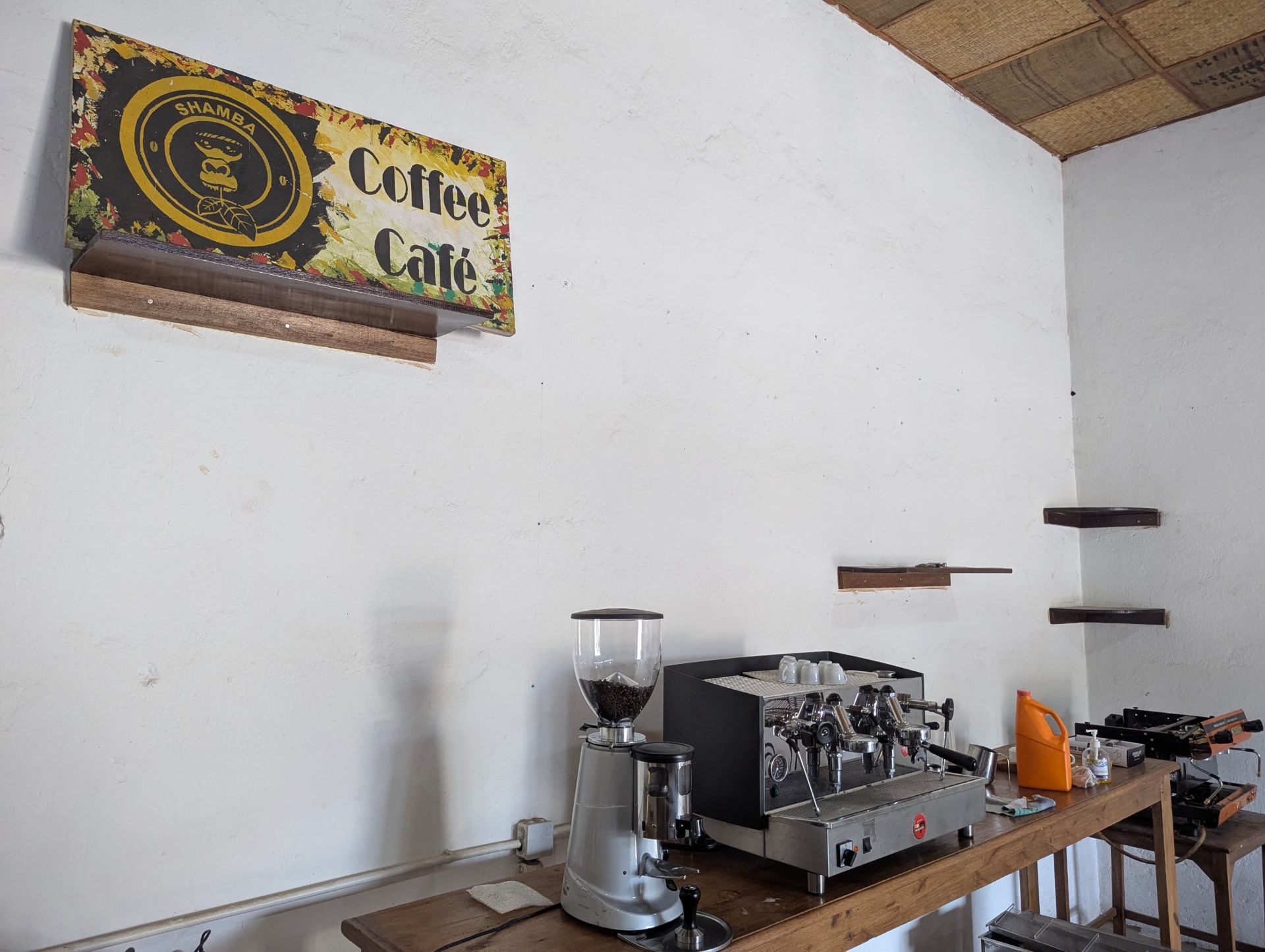Shamba Coffee Café signage above the barista bar